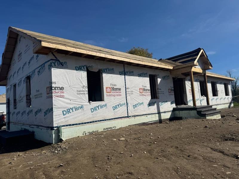 Bungalow with attached garage framed and wrapped