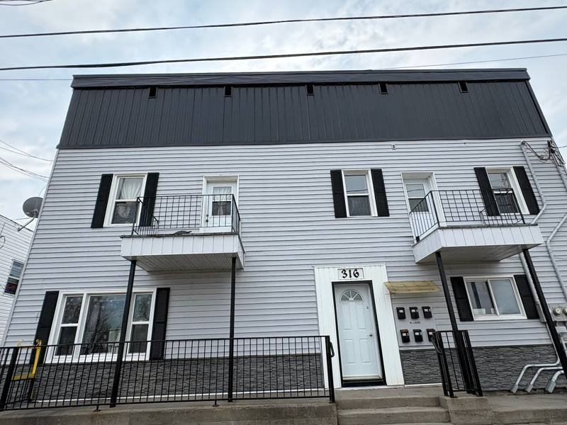 Multi-unit building with new balconies and siding