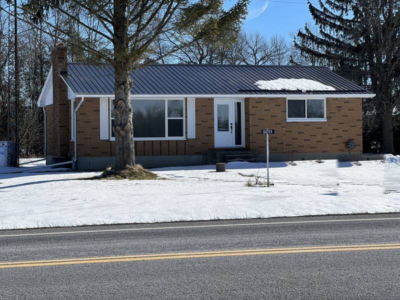 Standing-seam metal roof on a brick bungalow