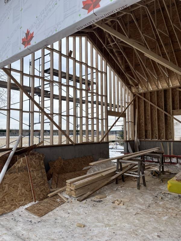Tall wall framing inside a large wood-frame building