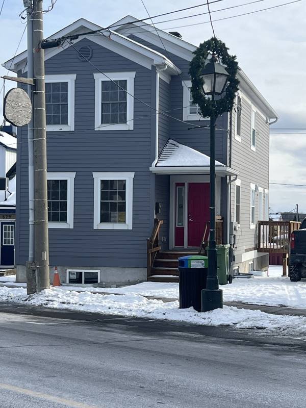 Two-storey building converted from commercial use to three residential units